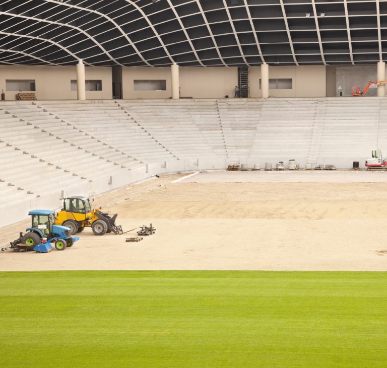 Stadium construction with machinery and groundwork.