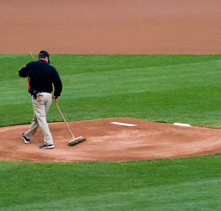 Groundskeeper preparing the baseball mound.
